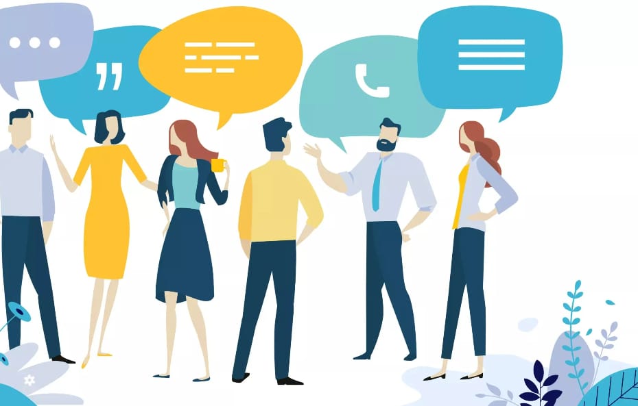 Six people are standing in a line, chatting with each other. They're all dressed in business casual attire with a mix of colours like yellow, blue, and grey. Above them are five speech bubbles in different colours - purple, blue, yellow, teal, and blue again - with symbols like quotation marks, lines, and a phone icon. There's some plant decor at the bottom corners. Looks like they're having a chill convo 