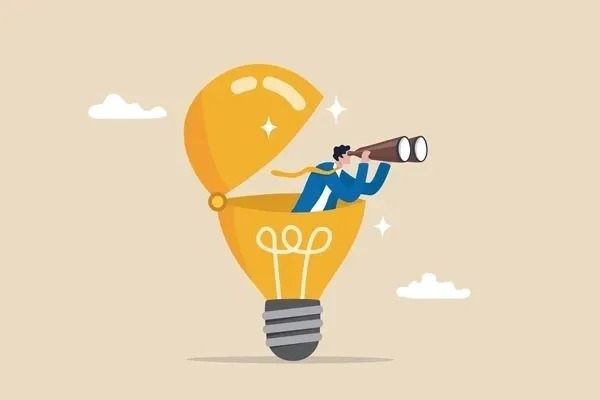 This image is a conceptual illustration of curiosity and exploration. It shows a person in a business suit sitting inside an open lightbulb, looking through a telescope. The lightbulb symbolizes ideas, innovation, and creative thinking, while the telescope represents curiosity, forward-thinking, and the drive to explore new possibilities. The overall message conveys how curiosity leads to new insights and opportunities, making it a fitting visual for an article about why employers value curiosity.