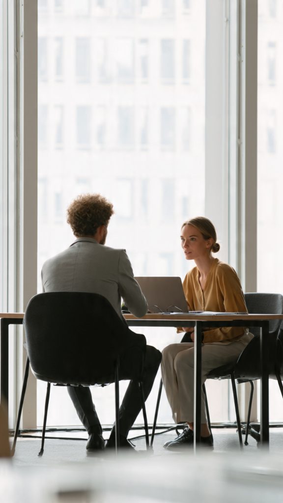 Performance Review
“A professional office meeting scene showing a young employee sitting across a desk from a manager during a performance review discussion. The atmosphere is calm, supportive, and professional. The manager is giving feedback while pointing at a document or laptop screen. The employee is listening attentively and taking notes. Bright modern office setting with natural light, minimal and clean background, subtle corporate environment. Include a sense of growth, learning, and career development. No text inside the image. Cinematic, realistic style, high detail, soft lighting, 16:9 composition (1600x778).”
